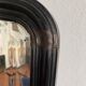 Miroir Napoléon III en bois noir à fronton