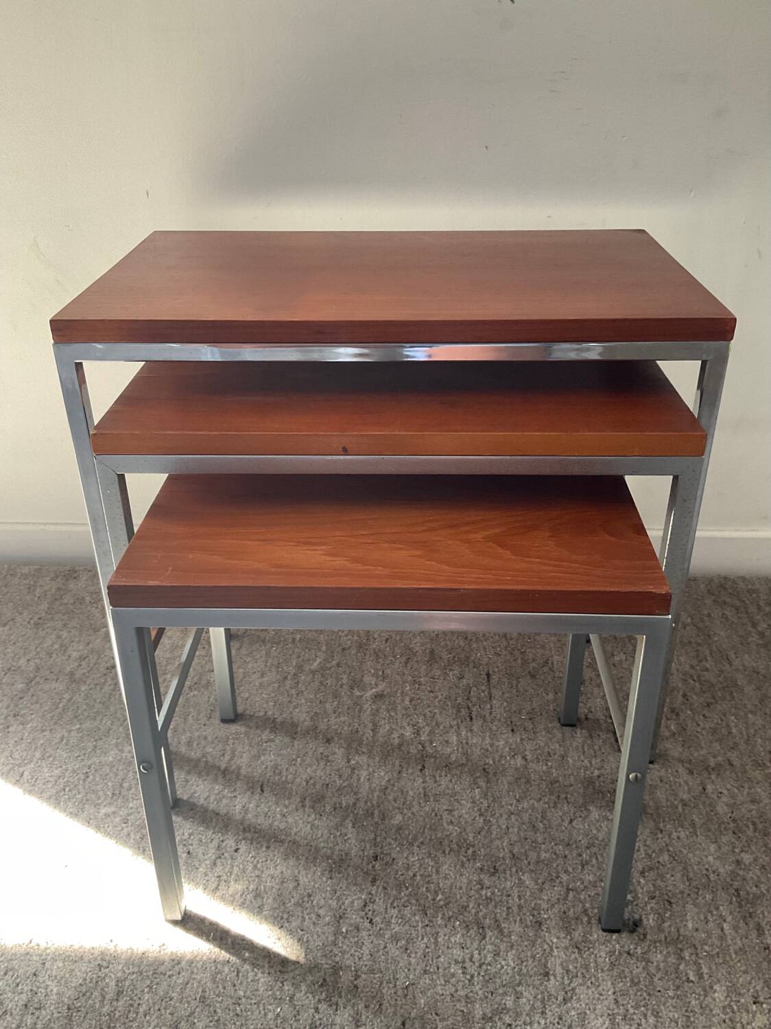 Trio of teak and chrome metal nesting tables from the 60s-70s