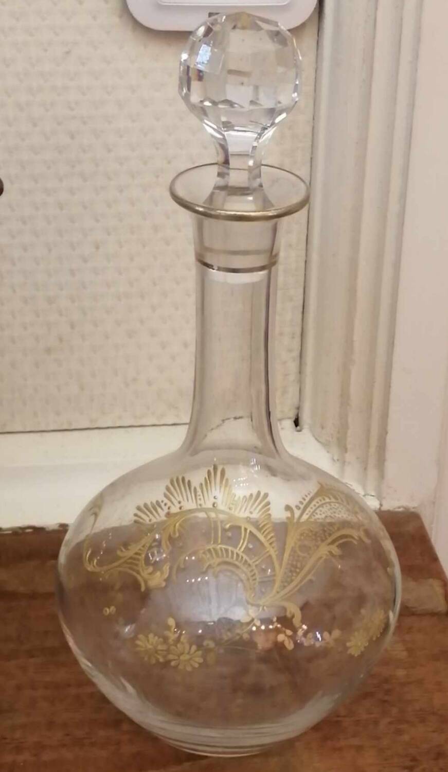 Old crystal decanter with gold decoration