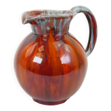 Large red and blue glazed ceramic pitcher signed Delène under the base