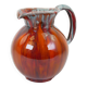 Large red and blue glazed ceramic pitcher signed Delène under the base