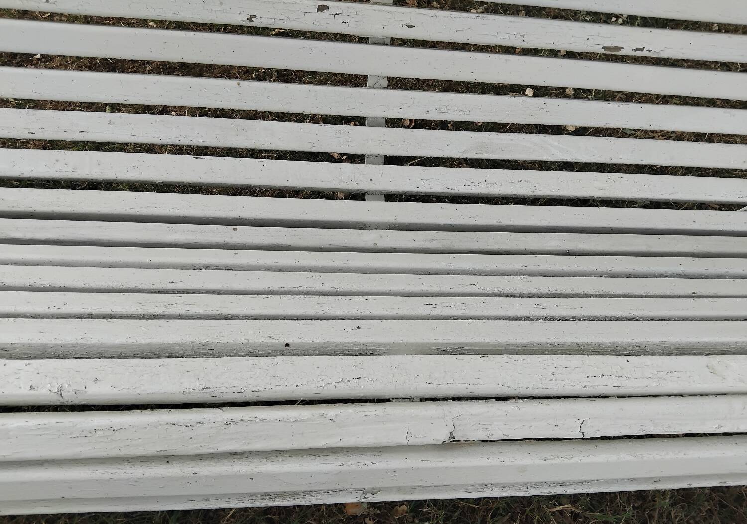 Old garden bench with metal legs and wooden slats