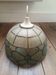 Mother-of-pearl and brass suspension with floral decoration.
