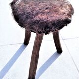 Rustic tripod stool seat covered with goatskin