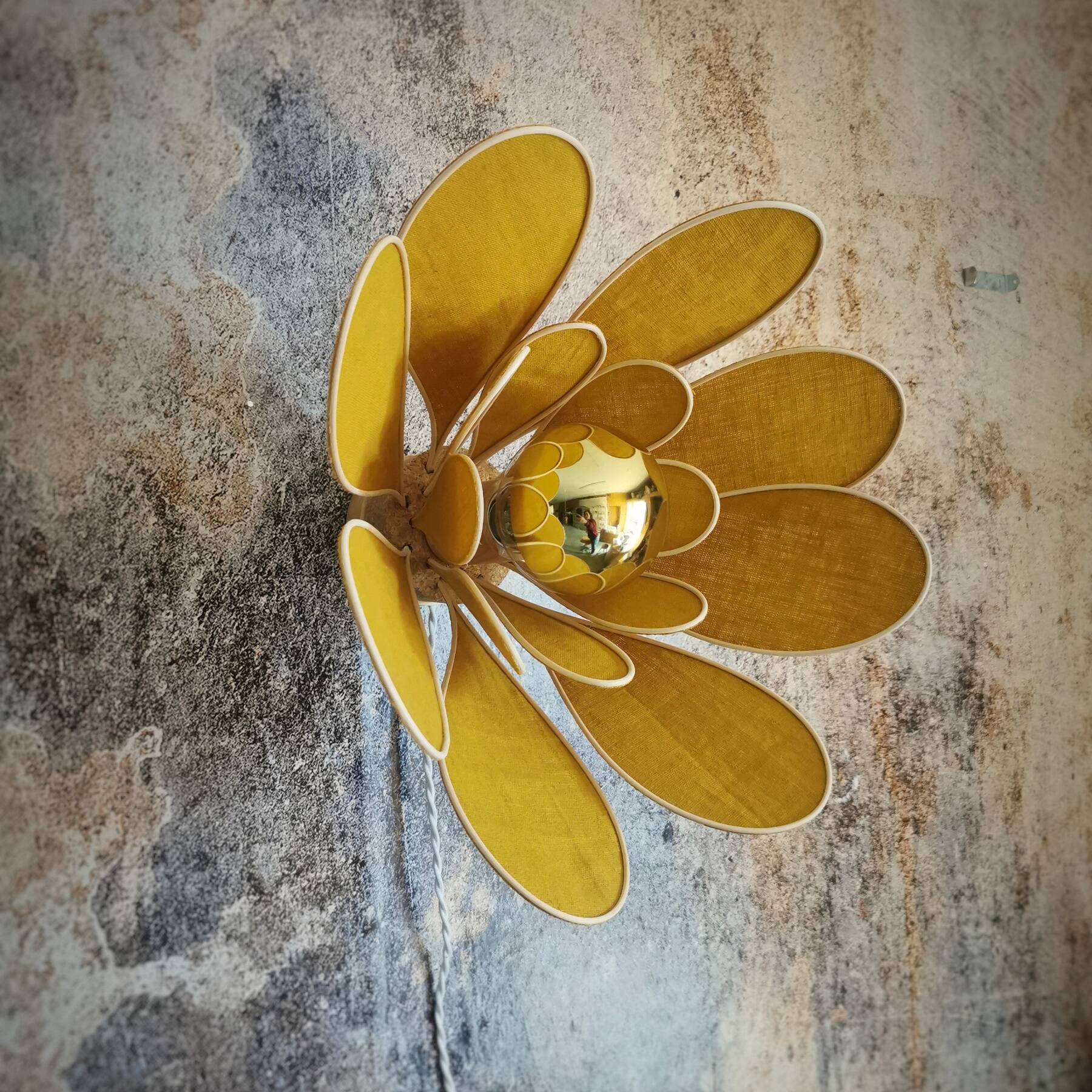 Flower wall light made of rattan and saffron linen petals