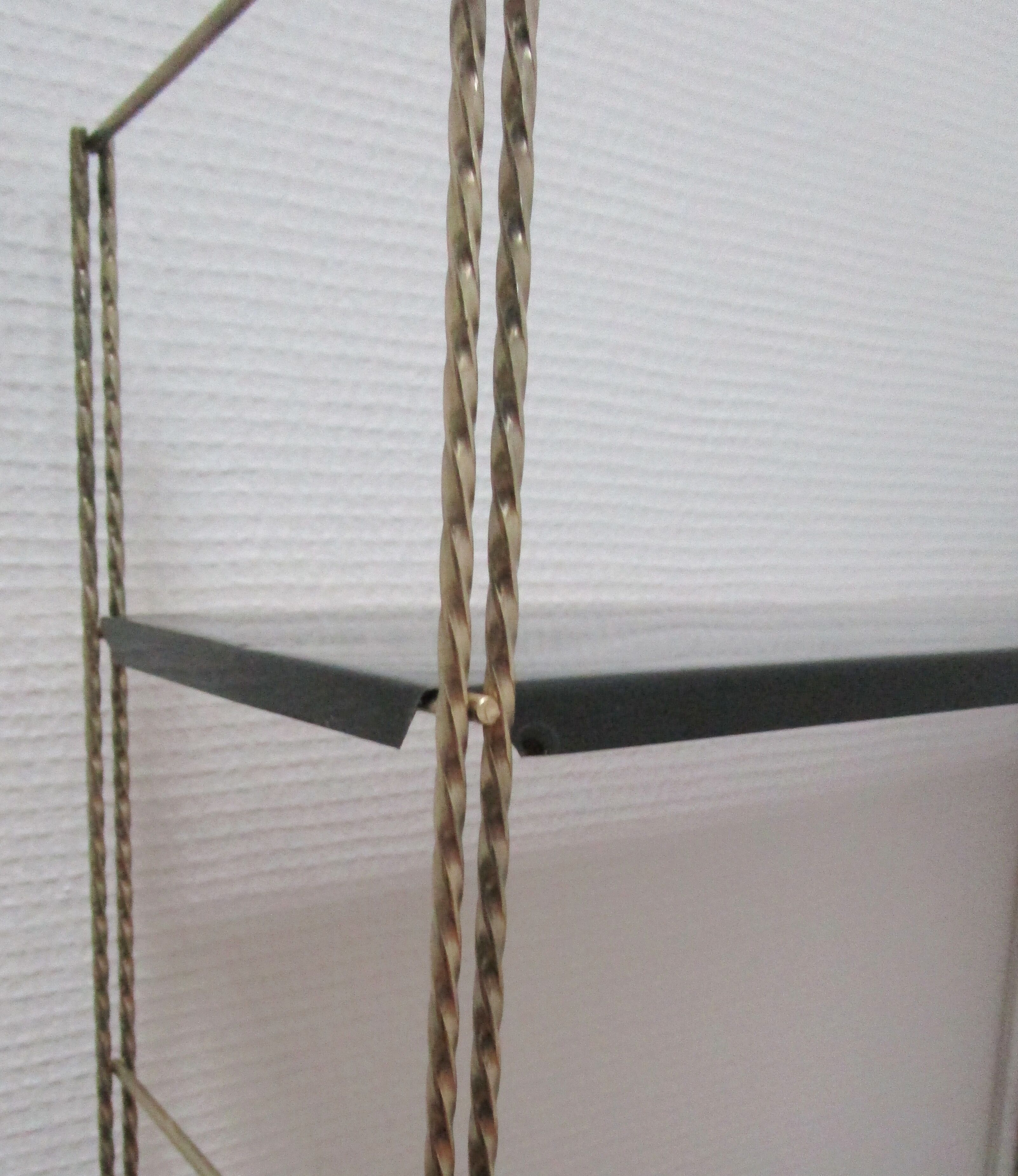 Black and gold metal tomado wall shelf