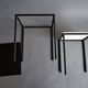 Pair of modernist nesting tables in black metal and white and black opaline 1960.