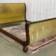Mahogany lit empire from the early 19th century with swan necks and claw feet.