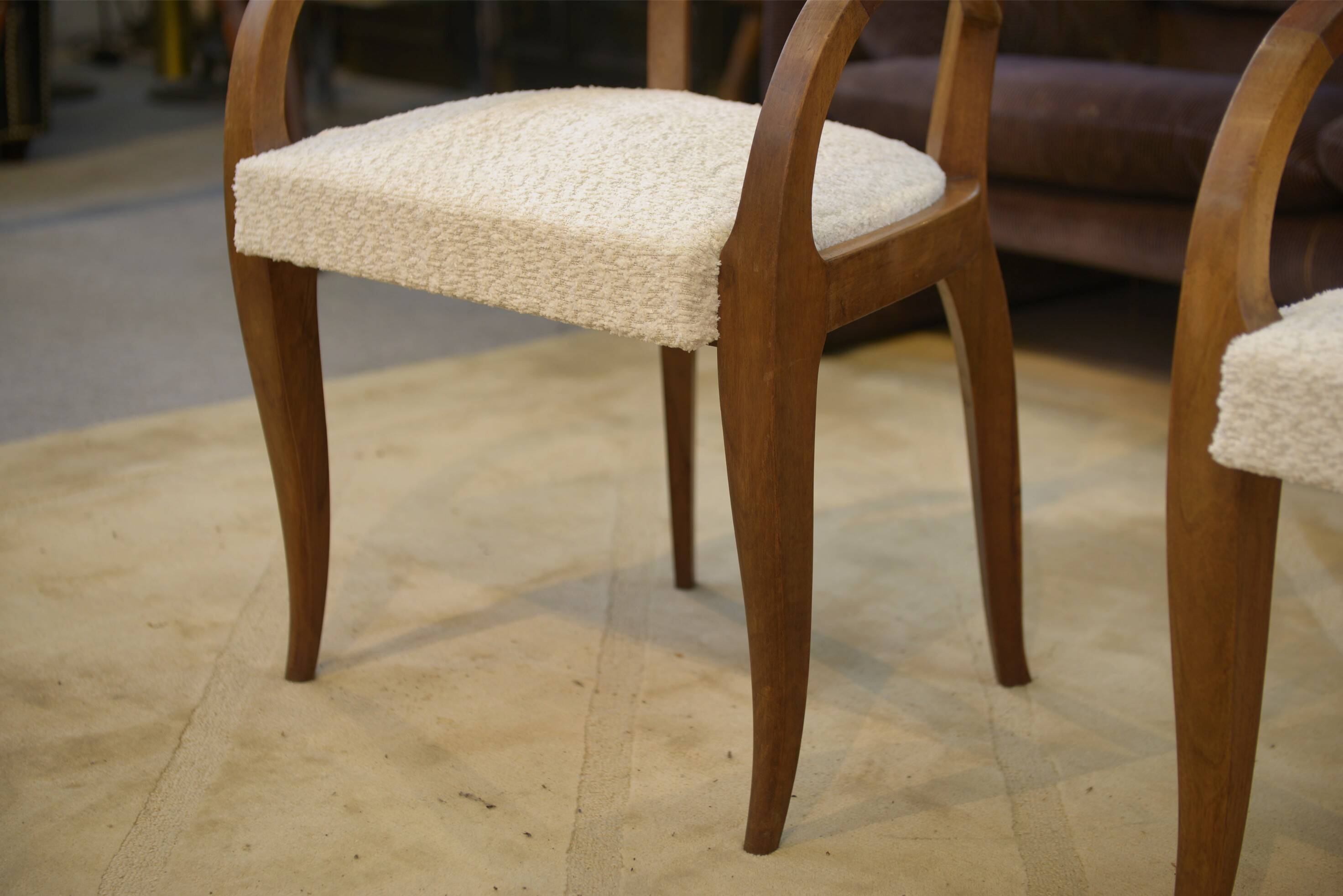 Pair of bridge armchairs in walnut and cream boucle fabric, early 20th century.