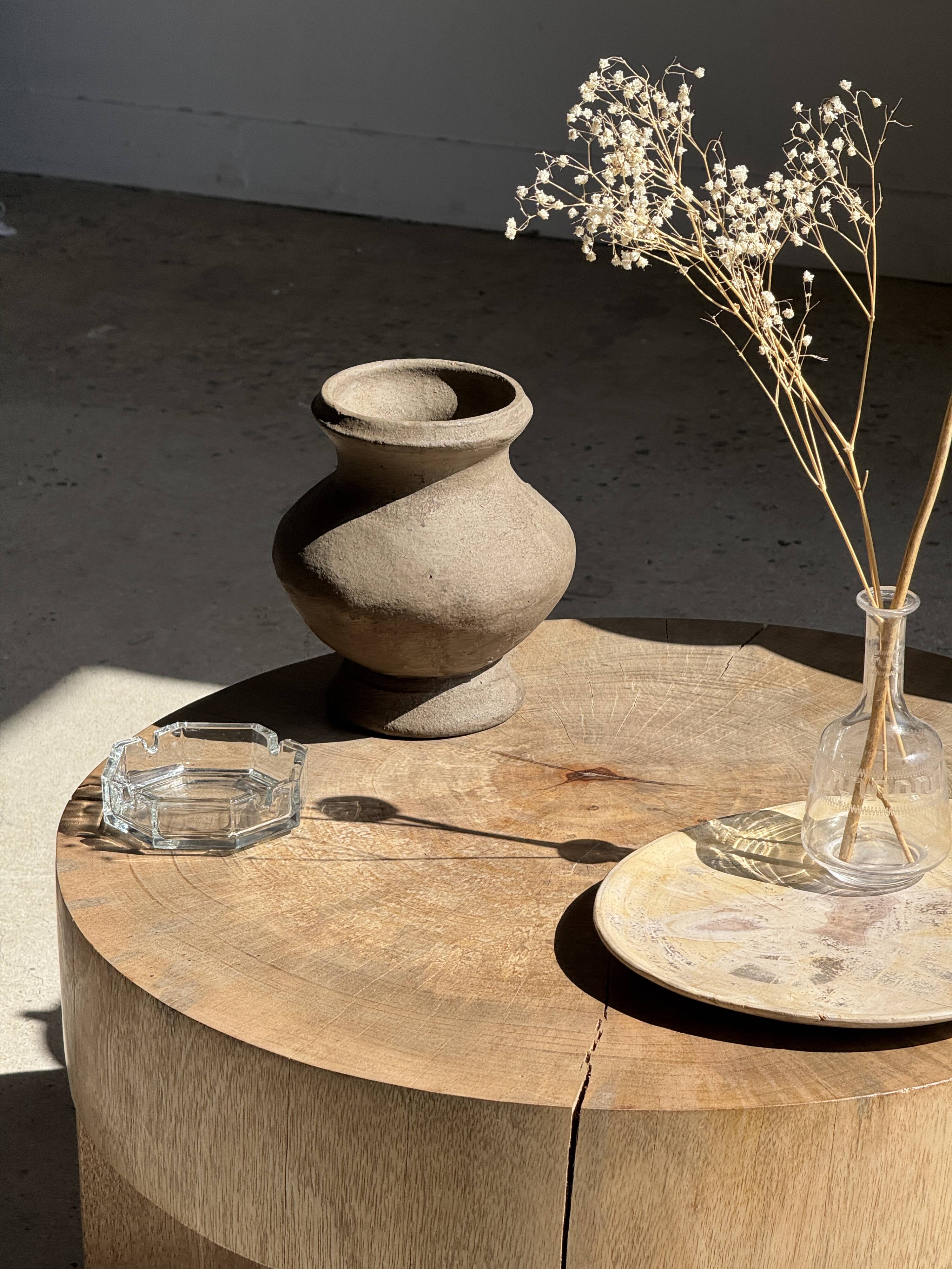 Petrified wood catchall or dish in beige with several grey spots in the centre.