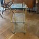 Elegant wheeled serving trolley in gilded brass and glass, in a spirit