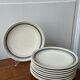 Set of 9 blue and beige striped plates.