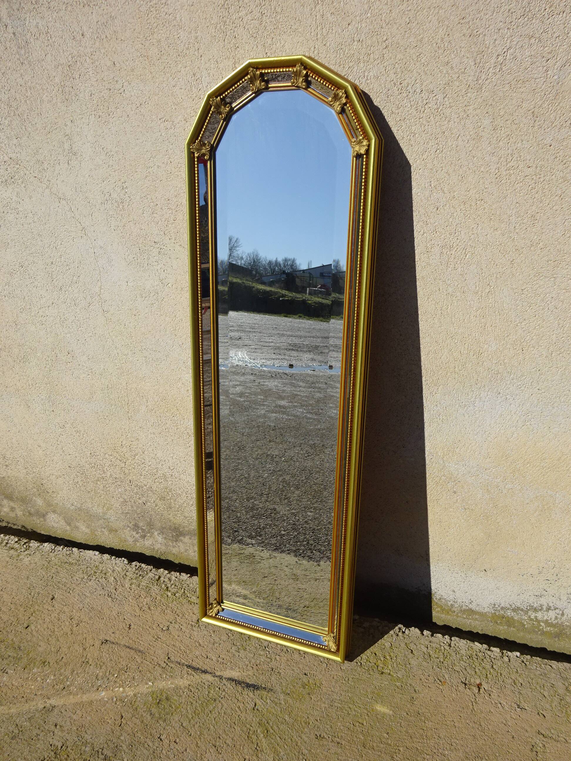 Vertical mirror, gold frame with beading.