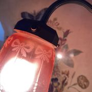 Antique jeweller's lamp, silver-plated base, frosted pink glass shade.