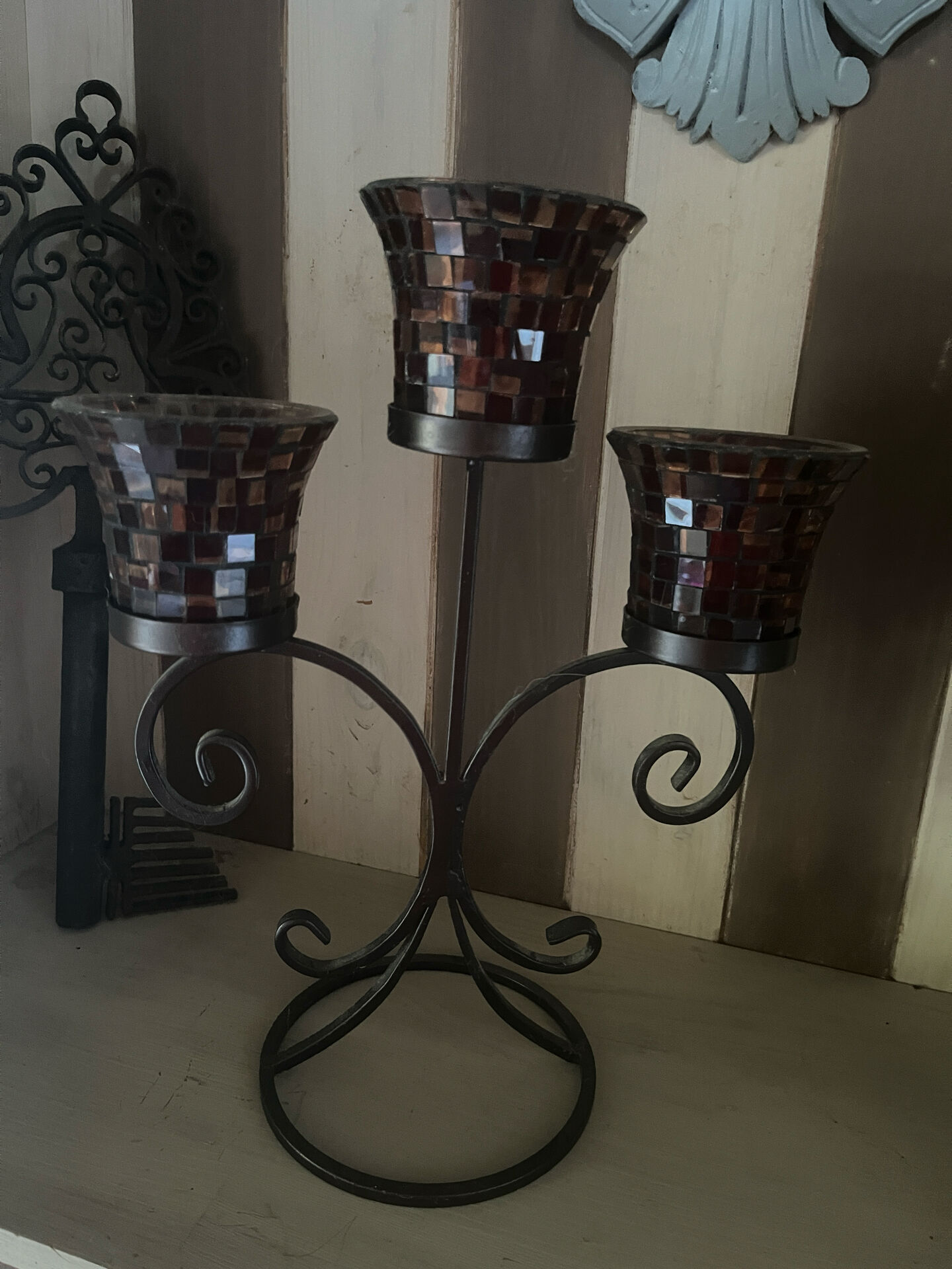 Three-branch candlestick in wrought iron and glass mosaic.