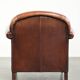 Sheepskin armchair with comfortable seat and finished with decorative nails