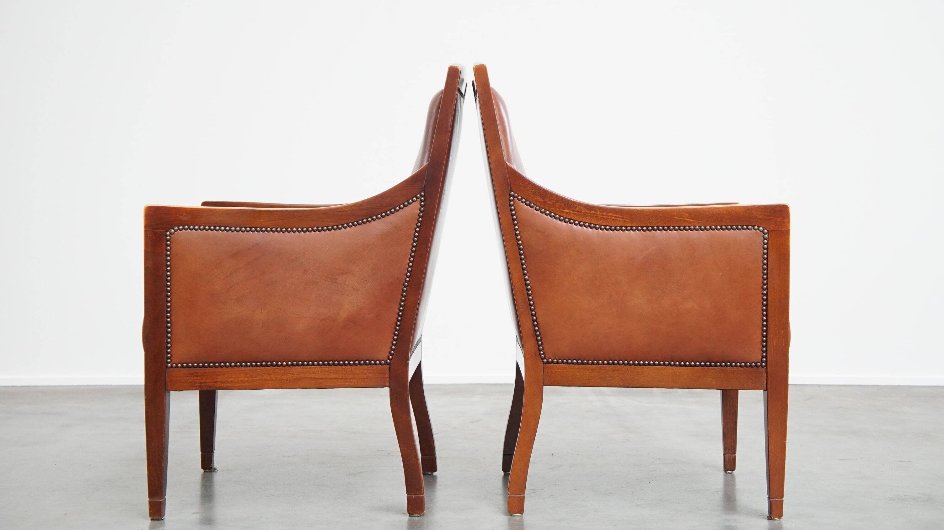 Set of 2 cognac-colored cowhide Art Deco design armchairs