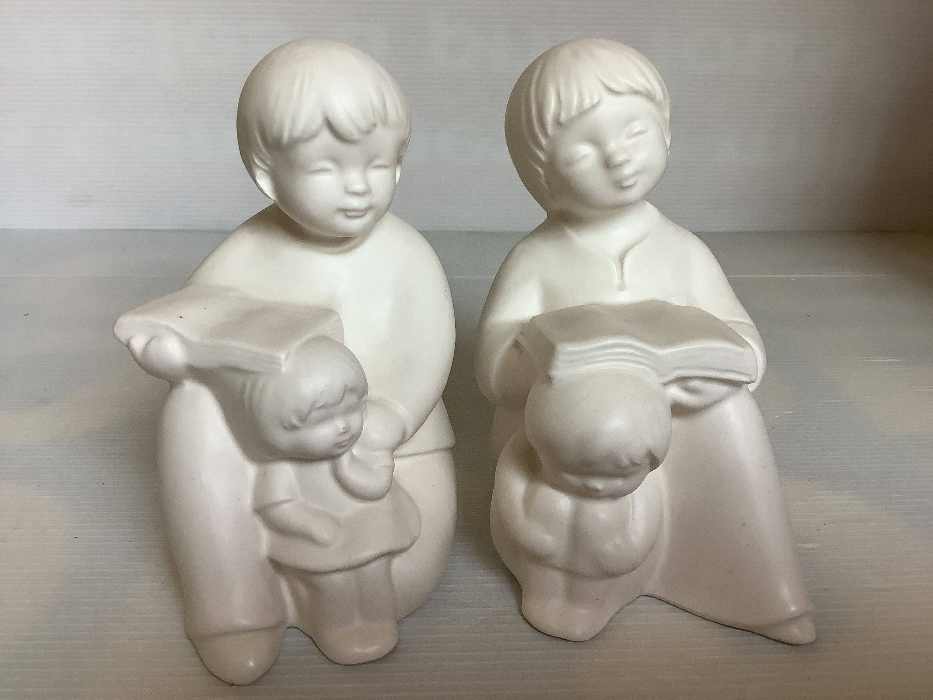 Pair of bookends with a matte white glaze for children.