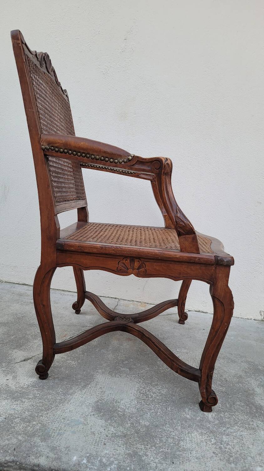 Louis XV Regency cane armchair leather armrests decorated with shell