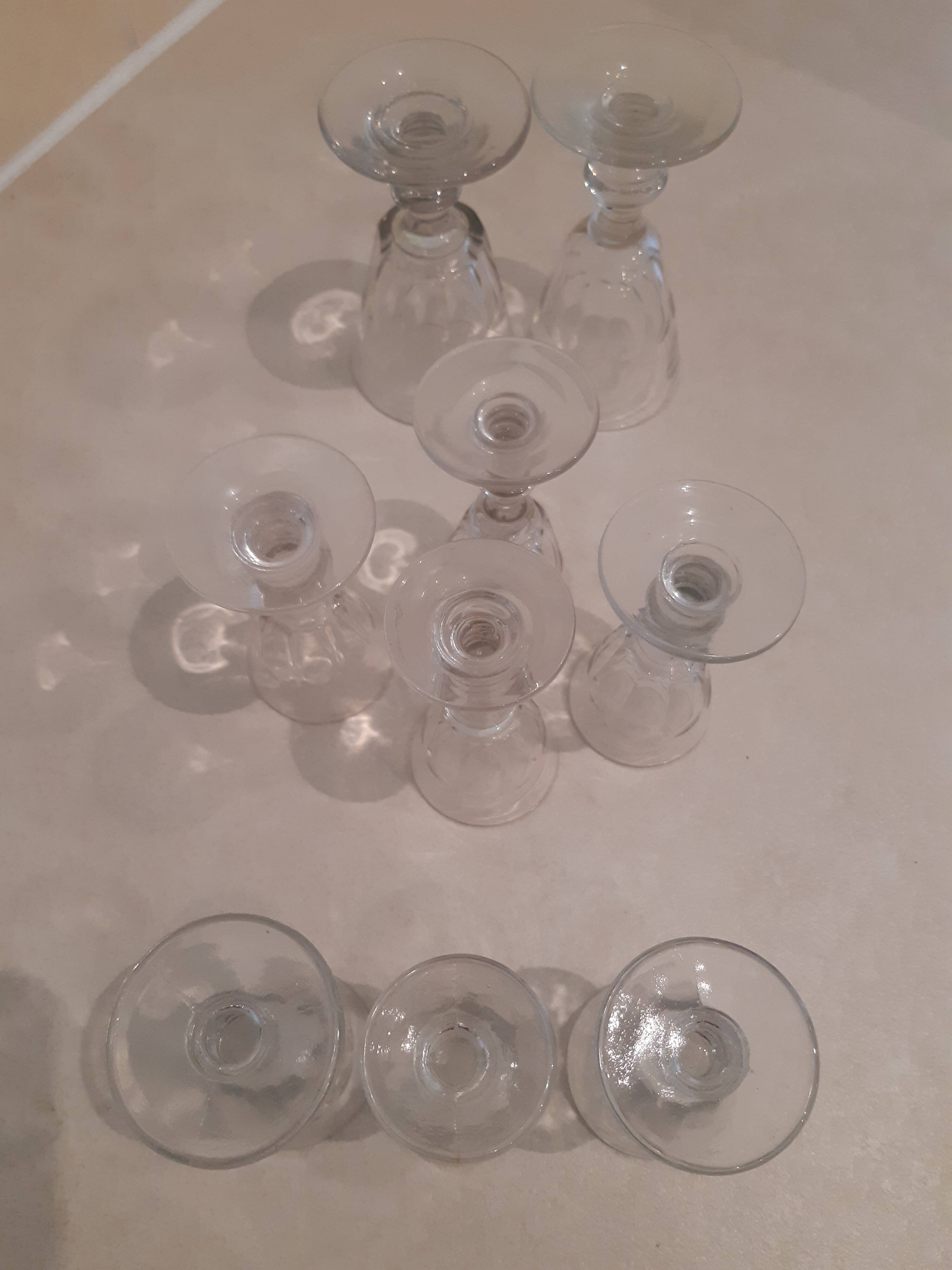 Set of 9 small cut glass stemmed glasses from the 1930s, in various sizes.