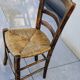 4 mismatched wood and straw chairs