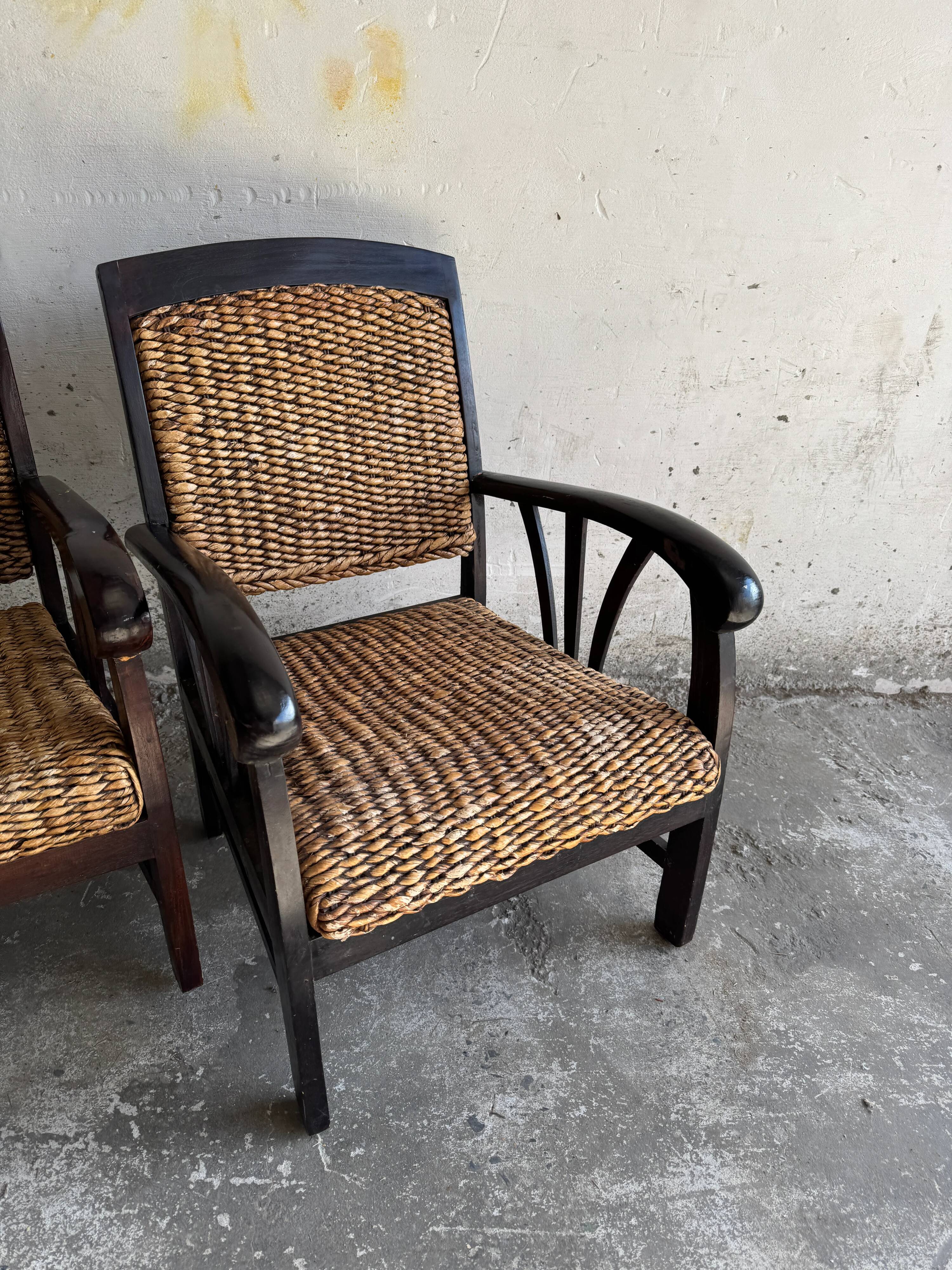 Set of two colonial dark-brown wooden armchairs with natural rattan seating (pair)