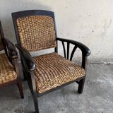 Set of two colonial dark-brown wooden armchairs with natural rattan seating (pair)