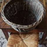 Round wicker basket with a patina