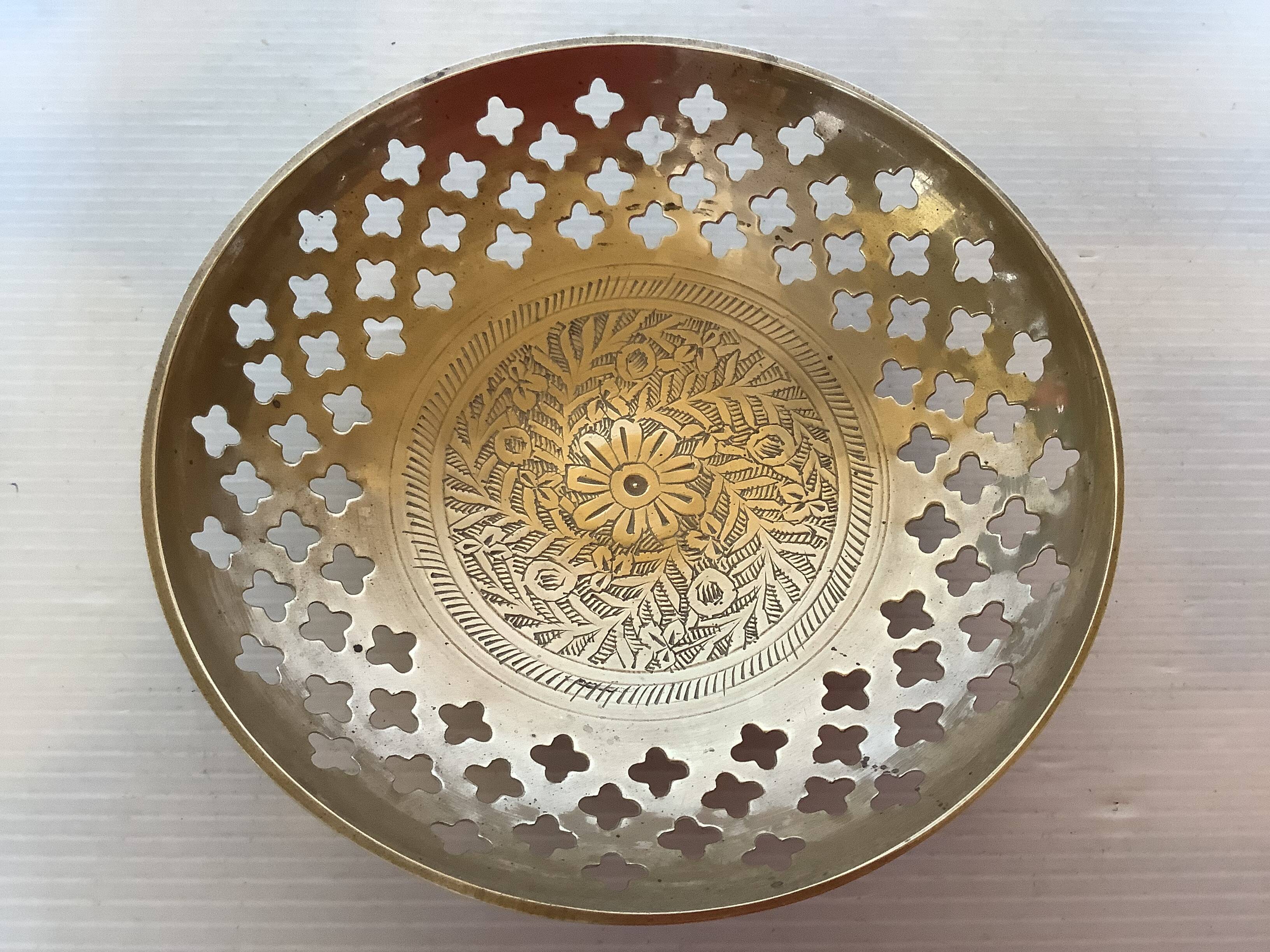 Lattice brass catchall and candlestick.