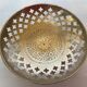 Lattice brass catchall and candlestick.