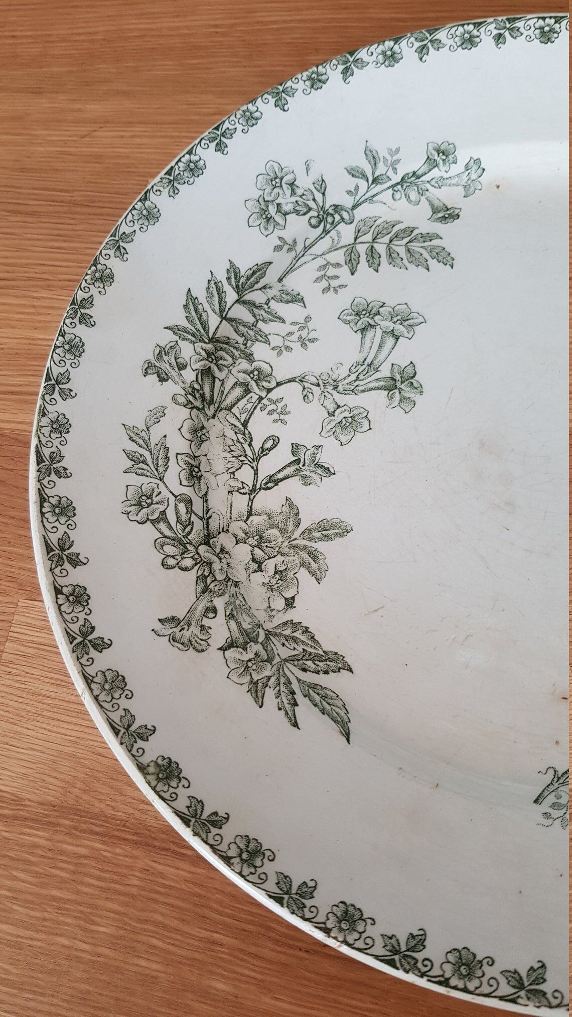 White and green ceramic dish decorated with flowers and butterflies