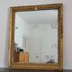 Golden stucco and wood Empire mirror