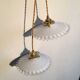 Pair of white opaline hanging with transparent serrated edges