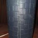 Ovoid lamp sheathed in braided blue leather and saddle stitching