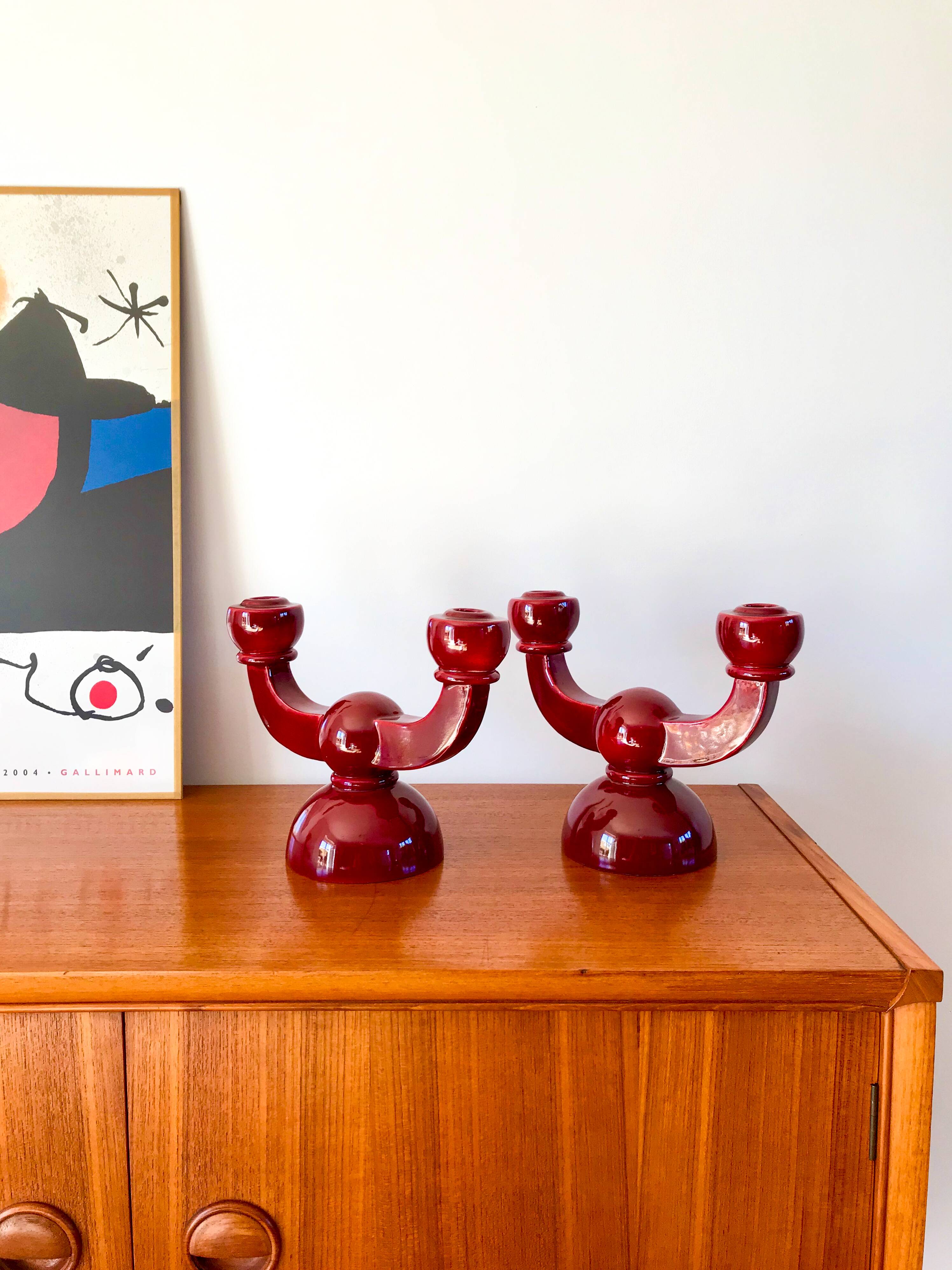 pair of burgundy enameled ceramic candlesticks / candelabras signed 1949