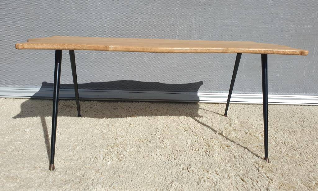 Violin-shaped coffee table with brass legs