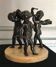 Three musician angels, bronze sculptures on a marble base.