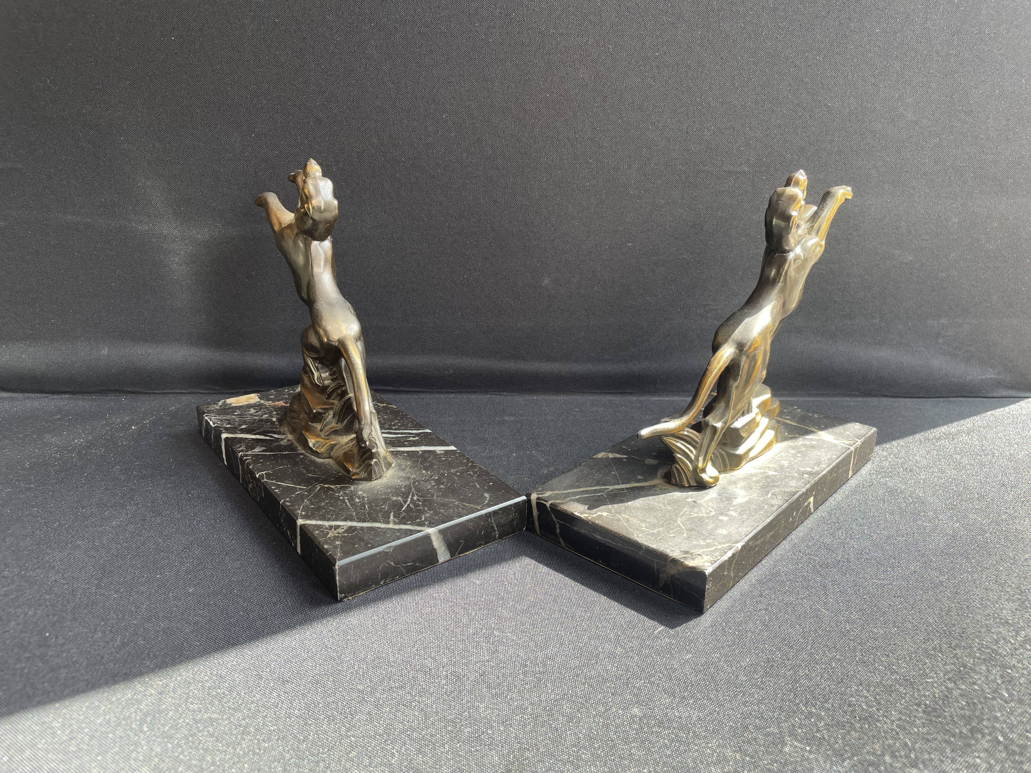 Pair of art deco marble and patinated regulated bookends