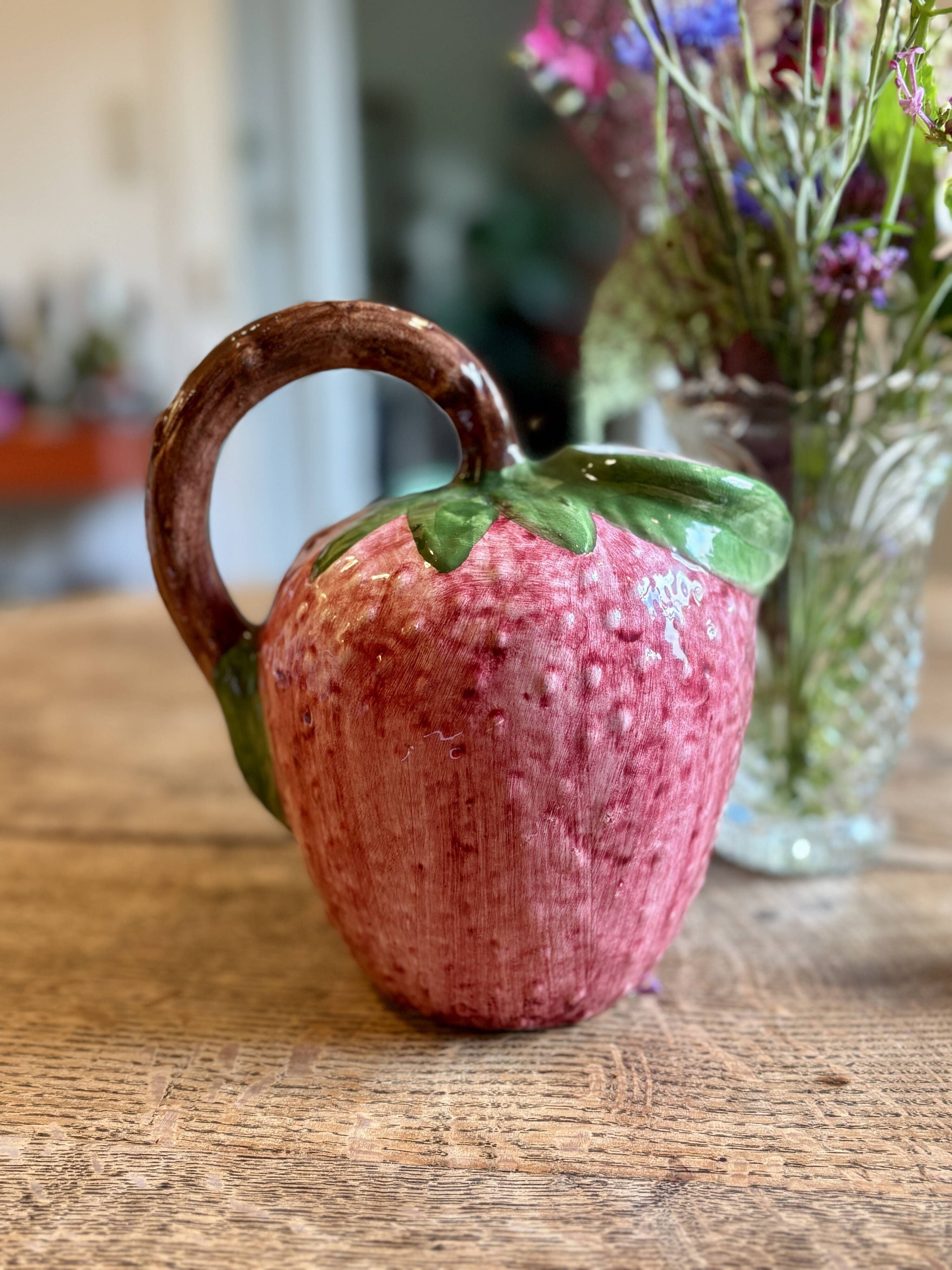 Ceramic jug in the shape of a strawberry.