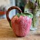 Ceramic jug in the shape of a strawberry.