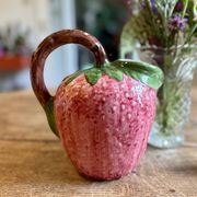 Ceramic jug in the shape of a strawberry.