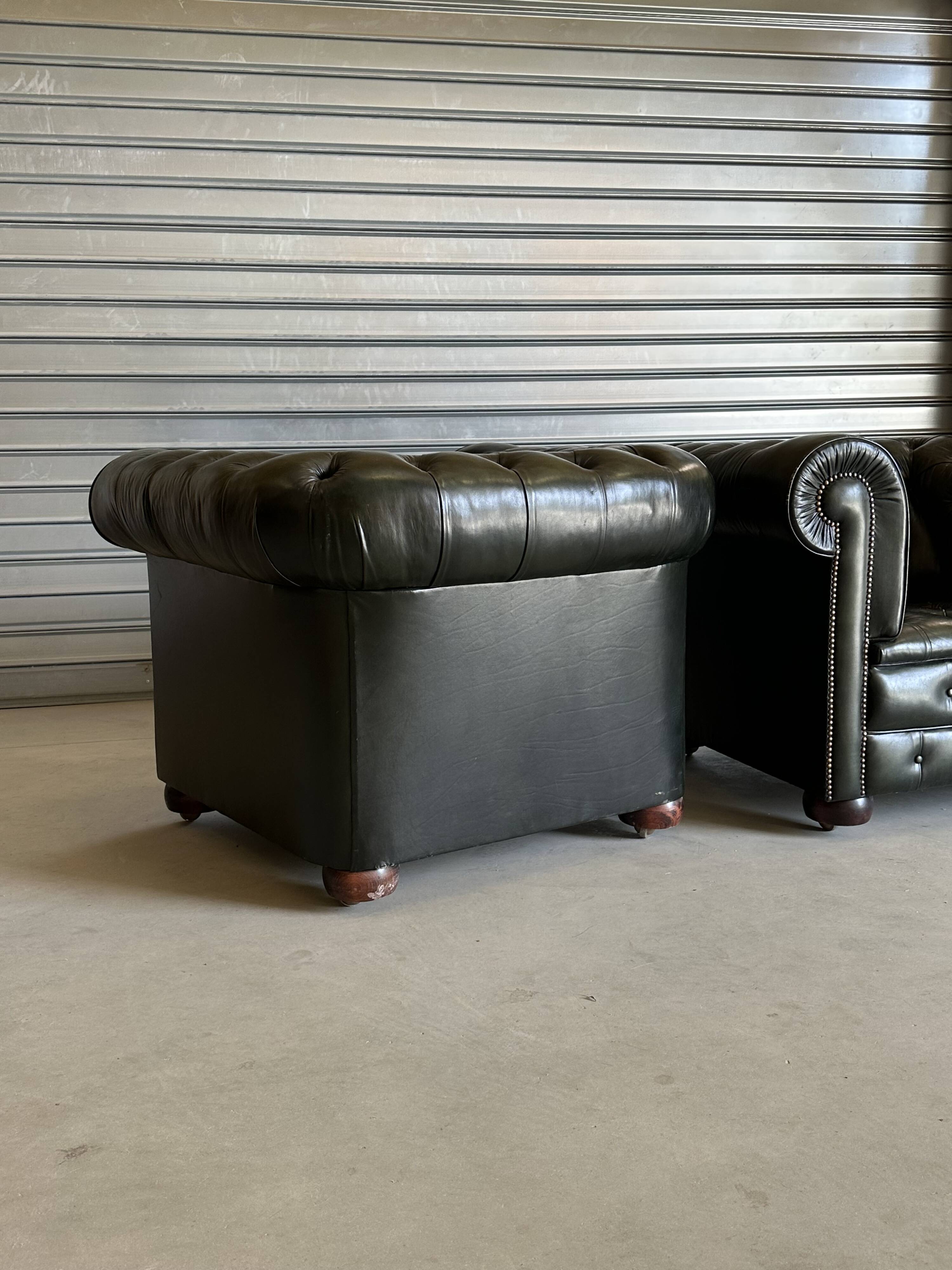 Title: Pair of vintage olive green leather Chesterfield armchairs