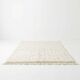 Ecru Moroccan rug with black dots.