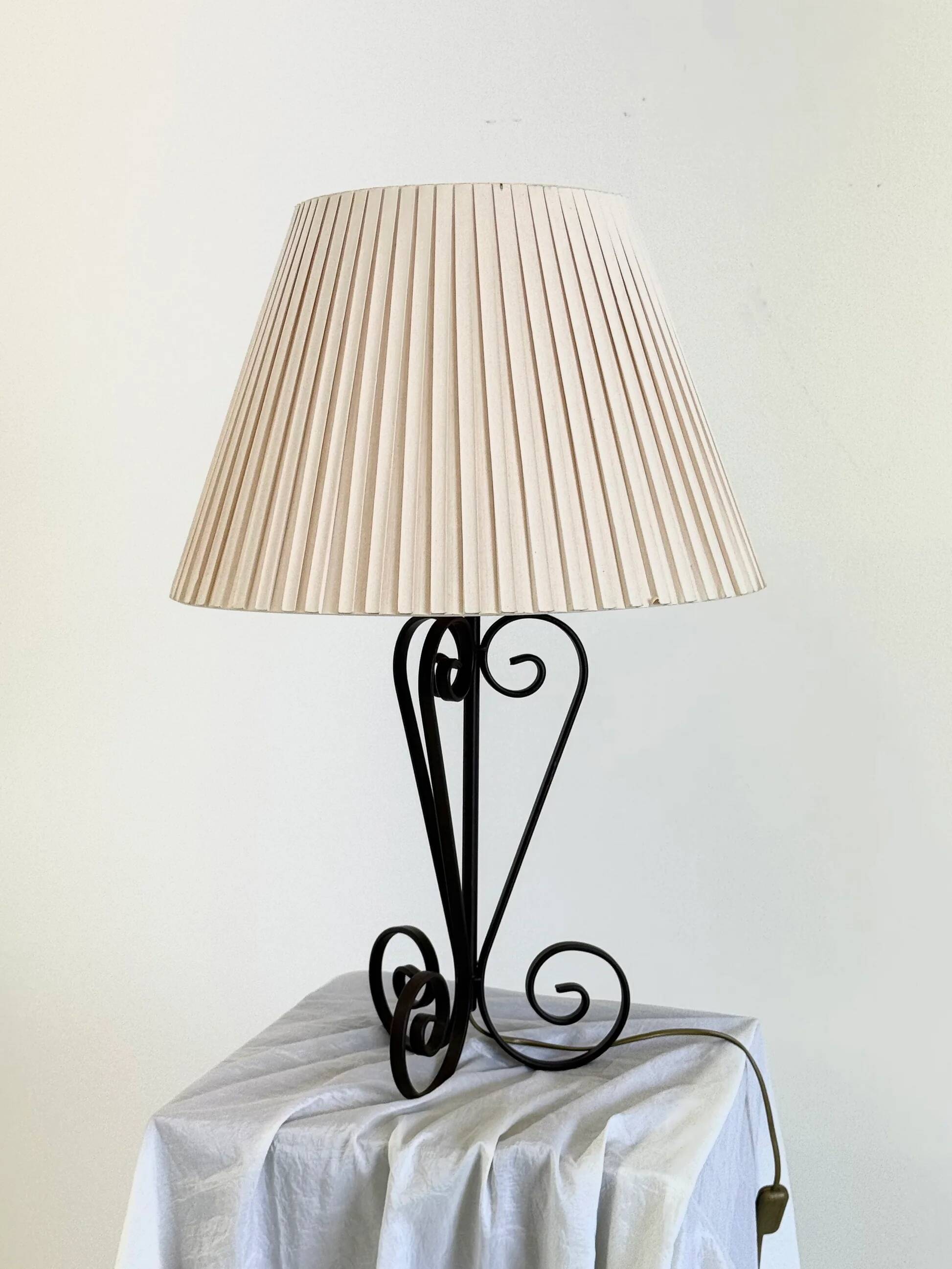 Vintage wrought iron table lamp in swirl shape with pleated shade