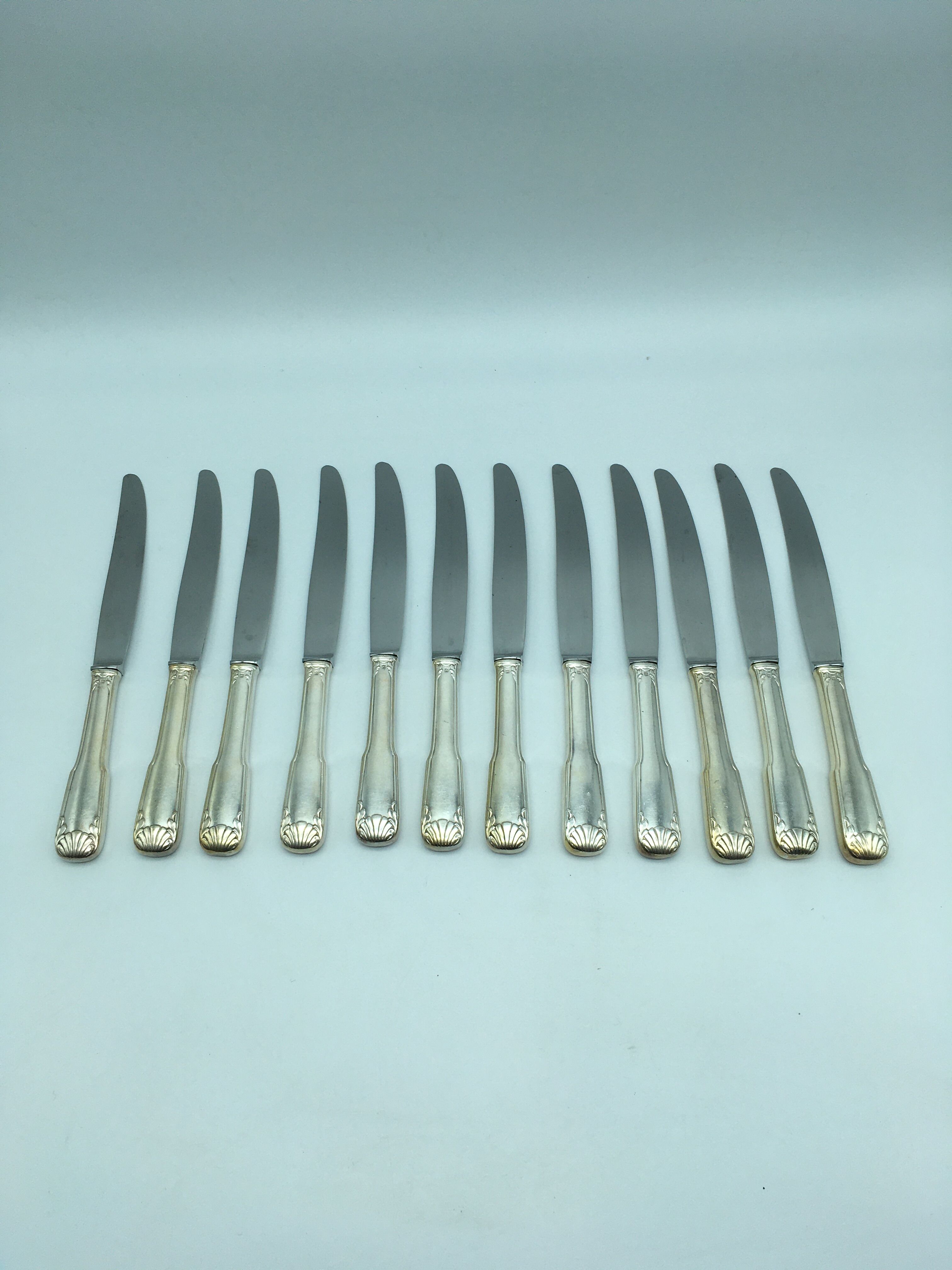 12 silver metal knives.