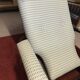 Rocking lounge chair made of fabric suitable for outdoor use.