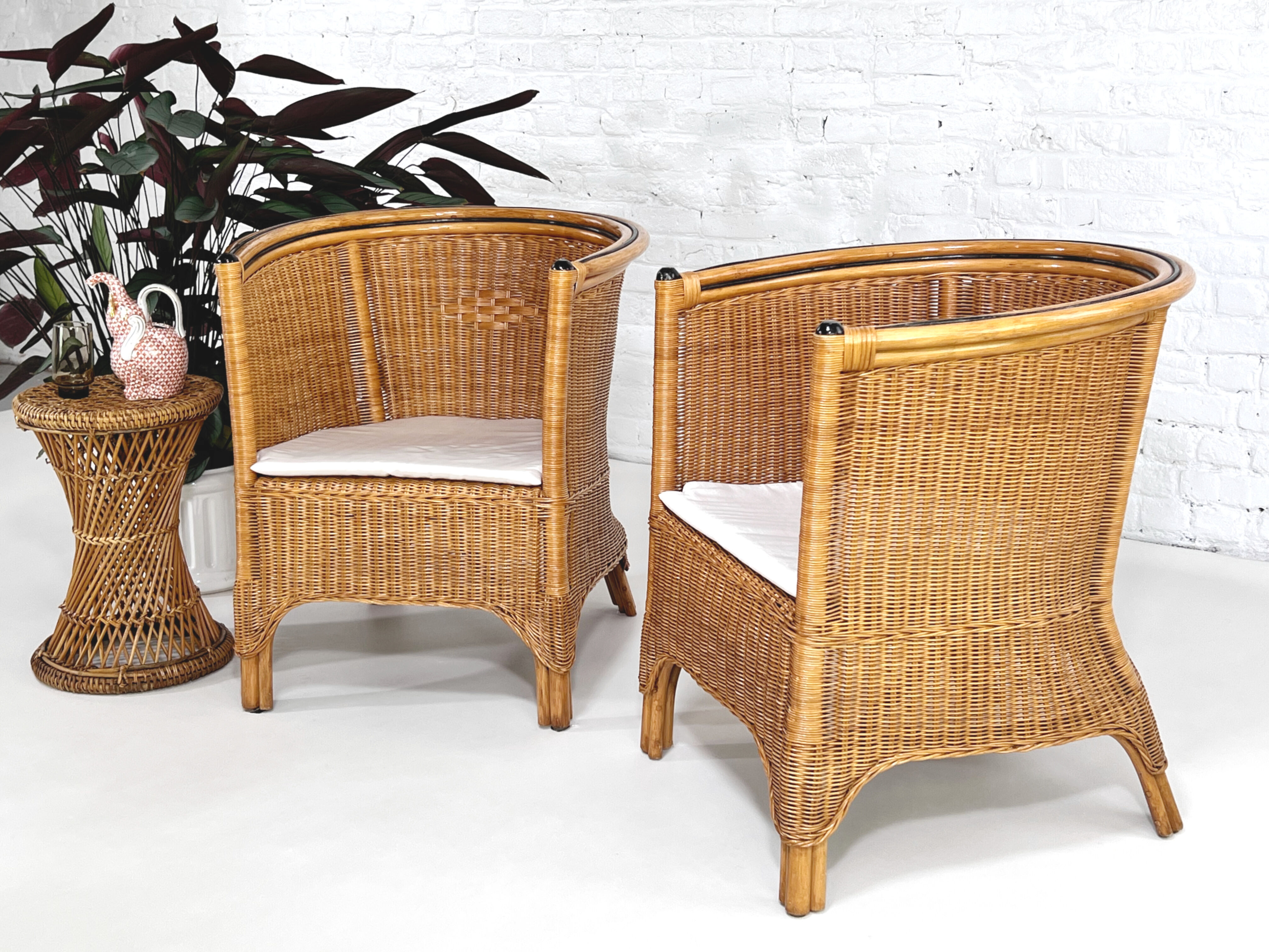 Pair of cabriolet armchairs in wicker and black edging