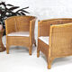 Pair of cabriolet armchairs in wicker and black edging