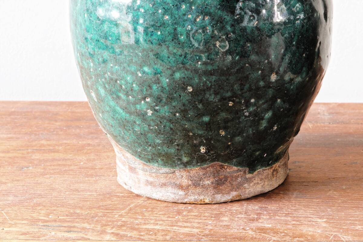 Set of two Chinese green glazed stoneware storage jars.