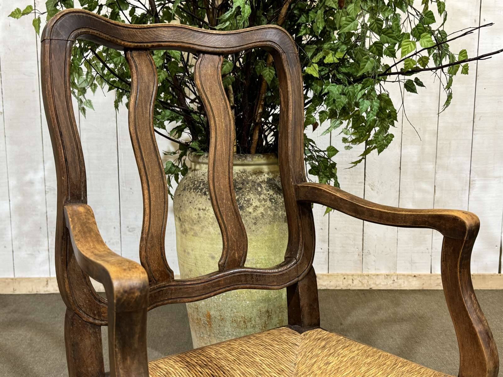 20th-century armchair in beech with a straw seat in Louis XV style.